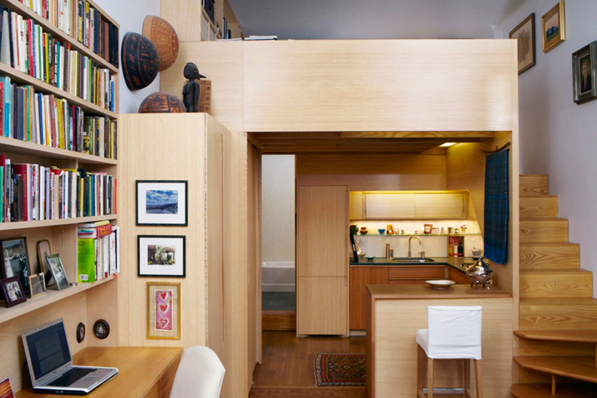 Architect Tim Seggerman's Nakashima-inspired studio apartment in NYC has a loft bed.